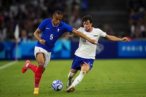 Kiliann Sildillia and Paxten Aaronson battle for the ball